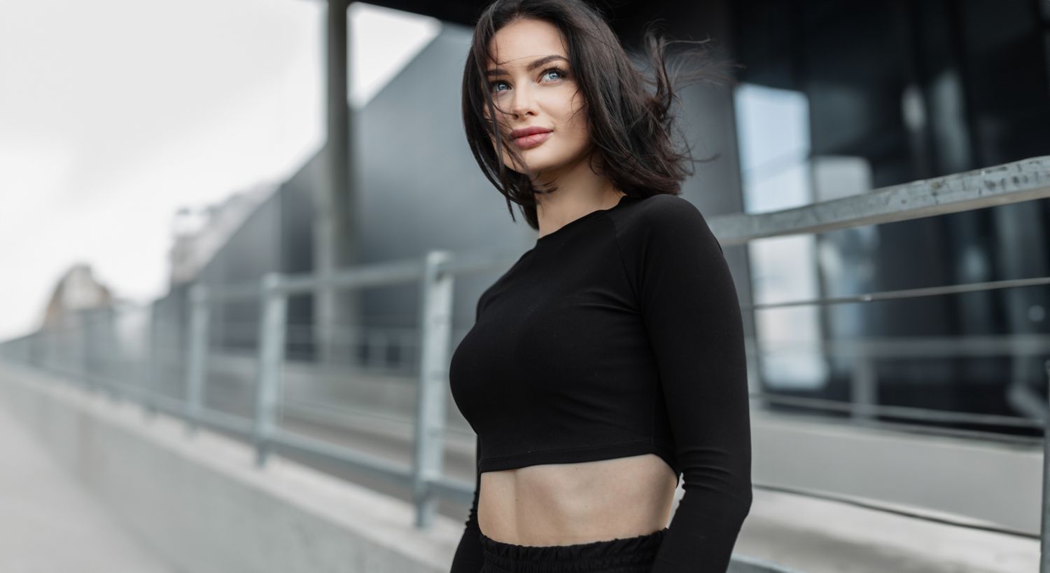 Woman with short hair in urban setting.